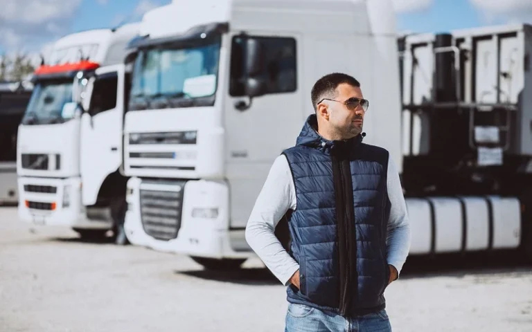 A men standing in front of Vehicle Transport Trucks